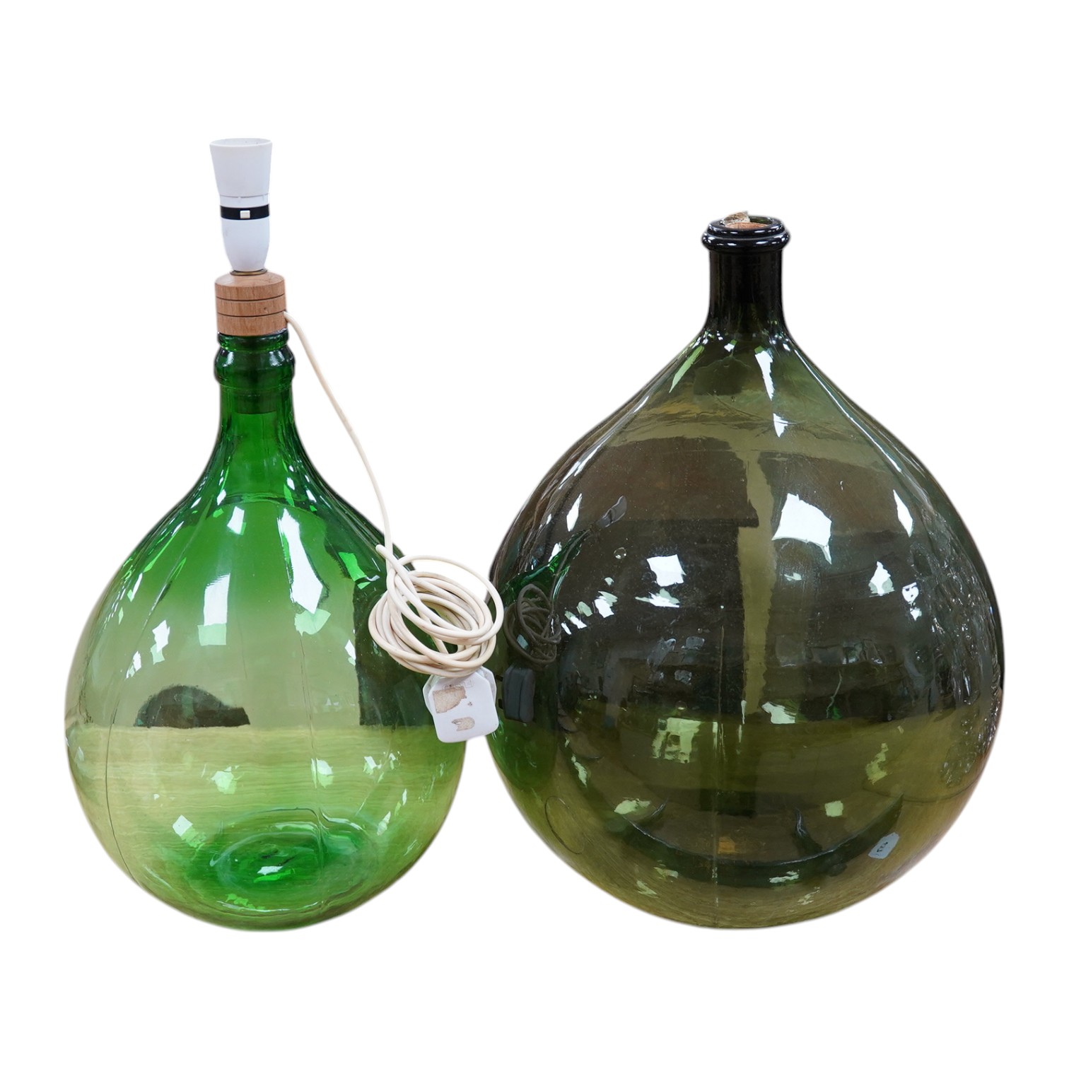 Two green glass carboys, one converted to a lamp, 58cm high overall. Condition - good, untested